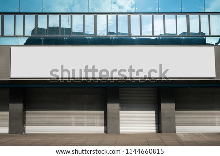 blank billboard on closed retail store - shop name mock-up / empty banner