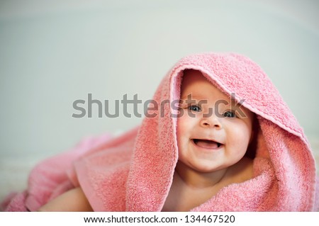 closeup portrait of happy child in towel