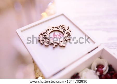 Beautiful toned picture with wedding rings lie on a wooden surface
