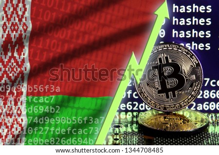 Belarus flag and rising green arrow on bitcoin mining screen and two physical golden bitcoins