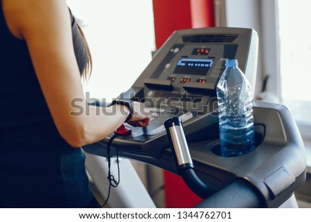A beautiful and athletic sportswear girl training in the gym