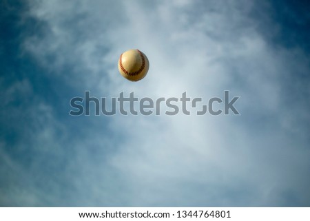 Flying baseball deep blue sky