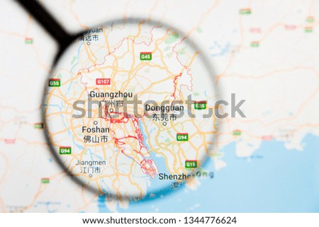 Guangzhou, China city visualization illustrative concept on display screen through magnifying glass