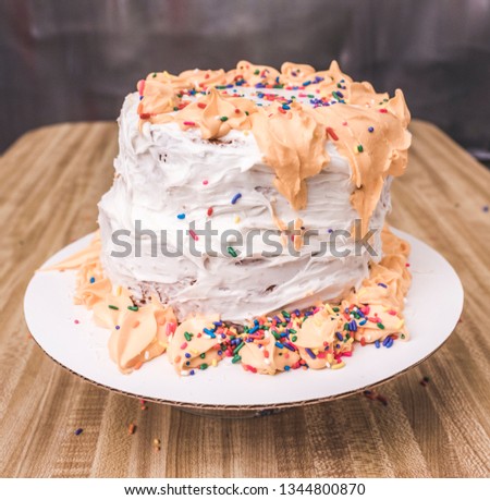 Nasty cake on a wooden table. Royalty-Free Stock Photo #1344800870