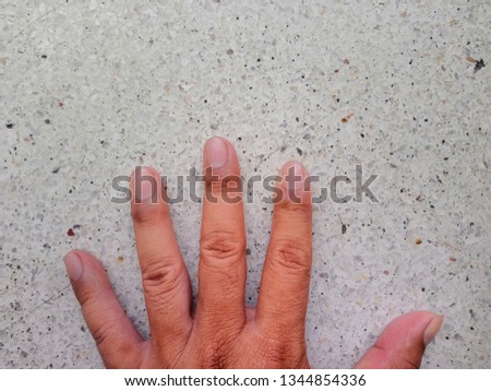 Fingers on the terrazzo floor