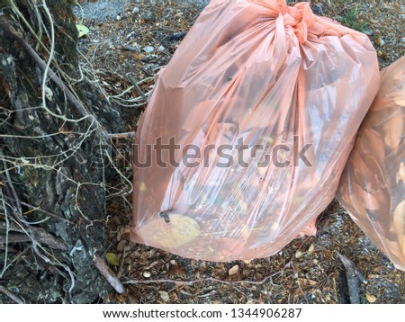 Two full rubbish bag left by the road side. 