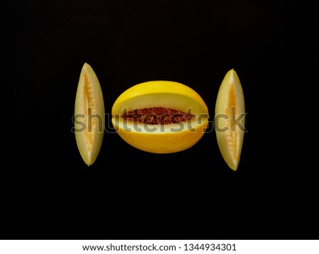 Yellow Melon Fruit isolated in black background viewed from above - flatlay look - Image Minimalism concept