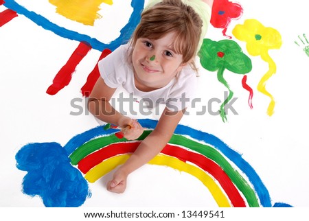 A cute young girl painting a picture