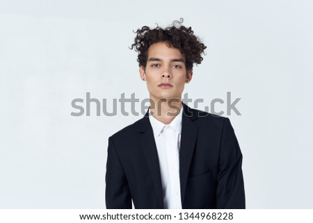 Handsome male curly hair suit cropped look                         