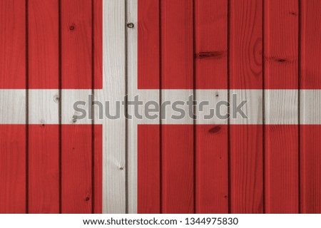 Flag of Denmark on the background of wooden boards. Wallpaper for installation and design. Space for text.