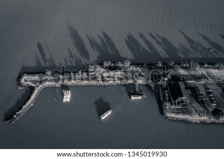 Melaka, Malaysia - Aerial view of a jetty with boats leaving towards an island.