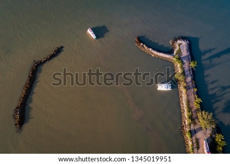Melaka, Malaysia - Aerial view of a jetty with boats leaving towards an island.