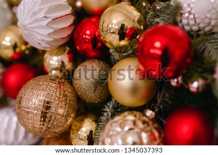 Merry Christmas and Happy New year Holidays! Decorating the Christmas tree indoors. Macro or close picture of xmas tree and gifts under it with red blue bulbs. Gift box background for 2020 gift card