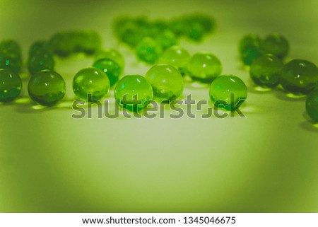 Bright green hydrogel round shape on clean background. Macro gel lime balls. Concept purity and minimalism. Classic abstract spring holiday wallpaper 