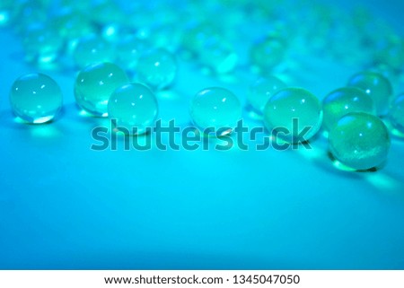 Bright blue hydrogel round shape on clean background. Macro gel balls. Concept purity and minimalism. Classic abstract wallpaper. Space for your text