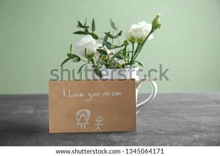 Greeting card for Mother's Day with flowers on grey table