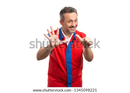 Joyful supermarket or hypermarket male employee holding up six fingers as counting sixth gesture isolated on white studio background