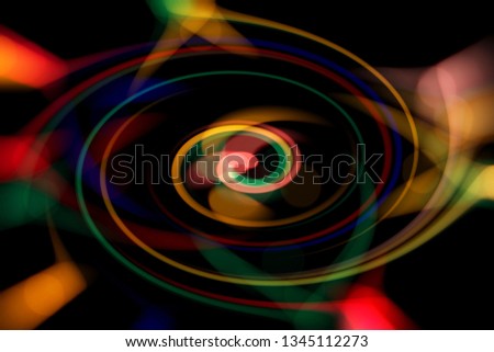 Blurred abstract background. Image of red, blue, green and yellow circles and wavy lines of different sizes.