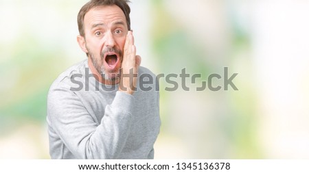 Handsome middle age senior man wearing a sweatshirt over isolated background hand on mouth telling secret rumor, whispering malicious talk conversation