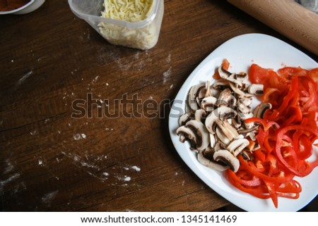 
ingredients for pizza, mushrooms, peppers, tomatoes, pizza sauce