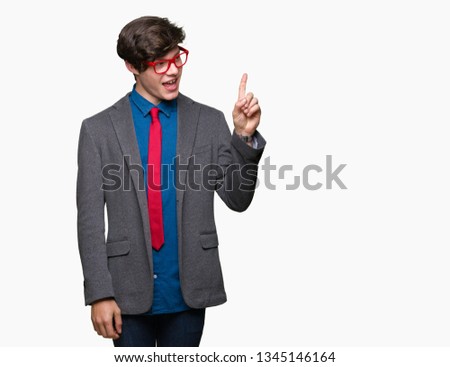 Young handsome business man wearing red glasses over isolated background with a big smile on face, pointing with hand and finger to the side looking at the camera.