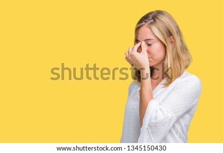 Beautiful young elegant woman over isolated background tired rubbing nose and eyes feeling fatigue and headache. Stress and frustration concept.