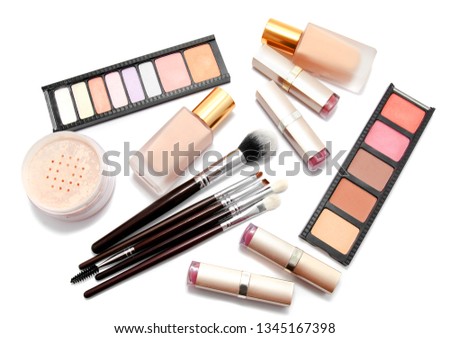 Various set of professional makeup brushes and cosmetics and palette of colourful eye shadows isolated over white background 