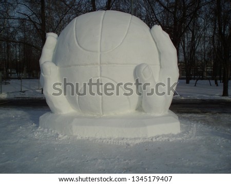  hands holding a basketball out of snow