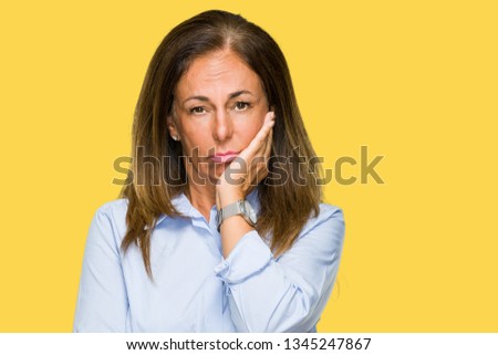 Beautiful middle age business adult woman over isolated background thinking looking tired and bored with depression problems with crossed arms.