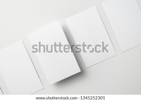 Design concept - top view of vertical business card isolated on white background for mockup, it's real photo, not 3D render