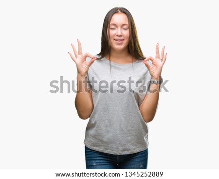 Young caucasian beautiful woman over isolated background relax and smiling with eyes closed doing meditation gesture with fingers. Yoga concept.
