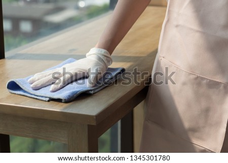 woman cleaner cleaning living room in apartment. portrait of asian woman cleaning staff doing housekeeping or domestic helper job. young adult asian woman model Royalty-Free Stock Photo #1345301780