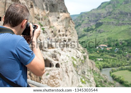 Photographer takes pictures Vardzia ancient cave city-monastery in the Erusheti Mountain, Georgia