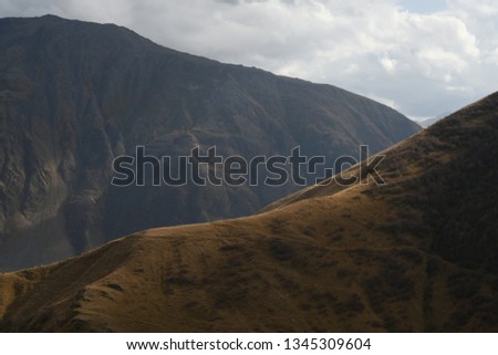 The shadow shot on Caucasus Mountains. Stepantsminda, Georgia