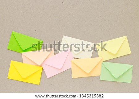 Colorful envelopes on grey paper background, copy space.
