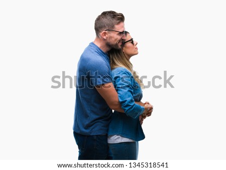 Young couple in love wearing sunglasses over isolated background looking to side, relax profile pose with natural face with confident smile.