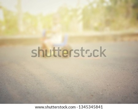 Boys riding bicycles in public roads in villages, blurred pictures