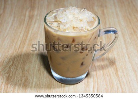 Street Drink : Iced coffee in glass on a brown wood table.