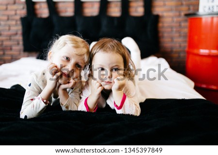 Little sisters playing in the stylish studio 