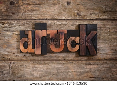 German word druck , translating to print , set with vintage letterpress printing blocks on rustic wooden background