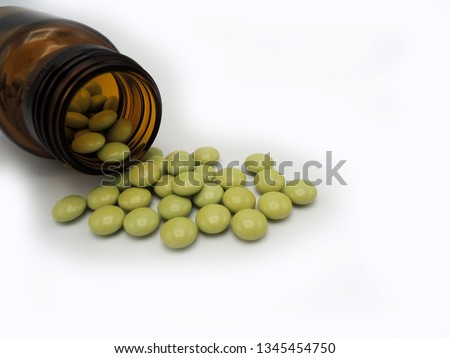 An opened bottle of green tablets of chlordiazepoxide and clindinium bromide. Chlordiazepoxide is a benzodiazepine, sedative and antianxiolytic. Clidinium bromide decreases intestinal spasms Royalty-Free Stock Photo #1345454750