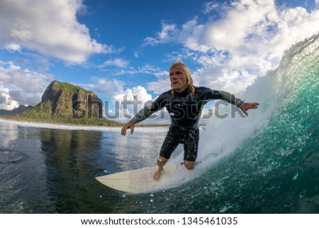 surfer riding on big waves on the Indian Ocean island of Mauritius