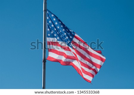 closeup of american flag on blue sky background