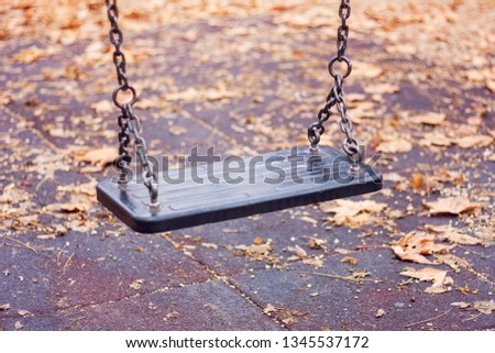 Empty swing in desolating autumn environment