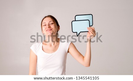 Portrait of young girl holding blank text bubble in specs isolated over white background