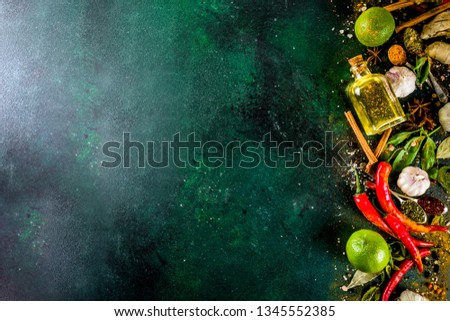 Various herbs and spices on dark background top view copy space