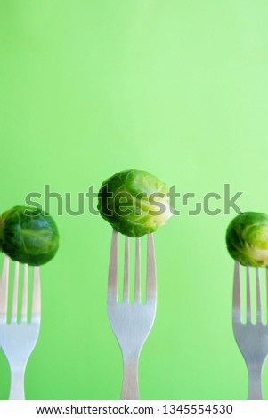 Brussels sprouts on a fork. Bright food with empty space for text