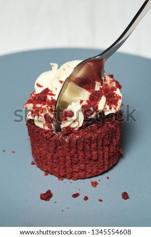 Red velvet cupcakes with cherry jam and crispy on white and black wooden backgrounds
