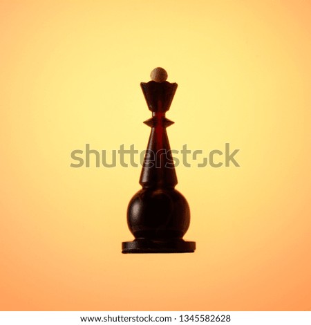 Amber chess set, chess piece Black Queen on gold gradient background.