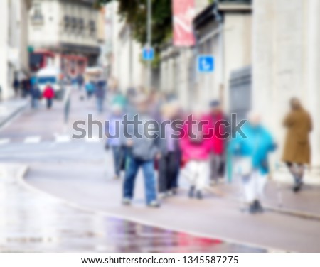 City in the daytime and passers-by. Strong blur, anonymous people on the streets of Europe